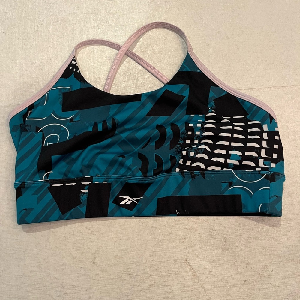Reebok teal and black graphic low impact sports bra. Split cross strap back.